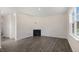 Living room with corner fireplace and wood-look flooring at 432 Ashley Run, Sanford, NC 27330