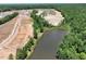 Aerial view showcasing new homes near a serene pond and wooded area at 432 Ashley Run, Sanford, NC 27330