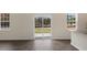 Sliding glass patio doors in a bright room with wood-look flooring at 432 Ashley Run, Sanford, NC 27330