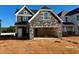 Two-story home with stone accents and a two-car garage at 57 Nimble Way # 182, Clayton, NC 27520