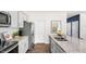 View of the kitchen showcasing stainless steel appliances, granite counters, and white cabinetry at 6444 Alfalfa Ln, Wake Forest, NC 27587