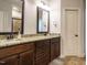 Double vanity bathroom with granite countertop and dark wood cabinets at 67 Meherrin Ct, Clayton, NC 27527