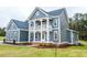 A beautiful blue two-story farmhouse with a spacious front yard at 71 Slocum Dr, Wendell, NC 27591