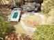 An aerial view of the property with a pool, circular driveway, and the back of the house at 7800 Secluded Acres Rd, Apex, NC 27523