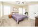 Bedroom with purple bedding, ceiling fan, and carpeted floors at 7800 Secluded Acres Rd, Apex, NC 27523