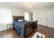 Cozy bedroom with wooden bedframe, chandelier, and hardwood floors at 7800 Secluded Acres Rd, Apex, NC 27523