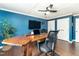 Home office featuring blue walls, wood desk, and hardwood floors at 7800 Secluded Acres Rd, Apex, NC 27523