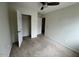 Empty bedroom with carpet, ceiling fan, open closet, and two doors at 8013 River Water Ct, Raleigh, NC 27616