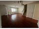 Living room with hardwood floors, stairs, and access to another area at 8013 River Water Ct, Raleigh, NC 27616