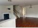 Living room with wood floors, fireplace, and staircase at 8013 River Water Ct, Raleigh, NC 27616