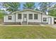 Charming single-story home with white siding, updated windows, and a welcoming front porch at 1001 Helms Pl, Raleigh, NC 27610