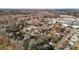 High-angle view of a residential area with houses, trees, and a factory in the background at 112 Edgewood Dr, Roxboro, NC 27573