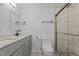 Bathroom with gray vanity, double sinks, and a walk-in shower at 112 Edgewood Dr, Roxboro, NC 27573