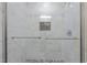 Modern shower with tile walls, pebble floor, and glass door at 112 Edgewood Dr, Roxboro, NC 27573