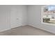 Unfurnished bedroom with double closet doors and a window at 112 Edgewood Dr, Roxboro, NC 27573