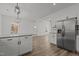 Modern kitchen with stainless steel appliances, white cabinetry, and granite countertops at 112 Edgewood Dr, Roxboro, NC 27573