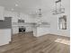 Open-concept kitchen and dining area with ample natural light, white cabinets, and modern appliances at 112 Edgewood Dr, Roxboro, NC 27573