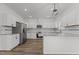 Updated kitchen with white shaker cabinets, stainless steel appliances, and a large island at 112 Edgewood Dr, Roxboro, NC 27573