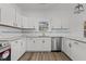 Bright, spacious kitchen with stainless steel appliances, white cabinets, and granite countertops at 112 Edgewood Dr, Roxboro, NC 27573