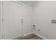 Laundry room with washer/dryer hookups and white door at 112 Edgewood Dr, Roxboro, NC 27573