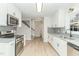 Modern white kitchen with granite countertops, stainless steel appliances, and gray tile backsplash at 182 Sierra Trl, Spring Lake, NC 28390