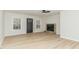 Living room featuring wood-look floors, a stone fireplace, and access to the front porch at 182 Sierra Trl, Spring Lake, NC 28390