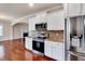 Stylish kitchen with stainless steel appliances, white cabinets, and granite countertops at 2499 Golden Forest Dr, Franklinton, NC 27525