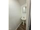 Pedestal sink and mirror in a small, clean bathroom at 2816 Smoke Pl, Raleigh, NC 27610