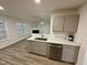Modern kitchen with island, stainless steel appliances, and white countertops at 2816 Smoke Pl, Raleigh, NC 27610