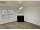 Living room with hardwood floors, fireplace, and large windows at 2816 Smoke Pl, Raleigh, NC 27610