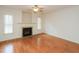 Living room with hardwood floors, fireplace, ceiling fan, and ample natural light at 4701 Sandy Bay Cir, Raleigh, NC 27603