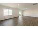 Large, open living room with wood-look floors and sliding glass doors at 14 Tributary Way, Fuquay Varina, NC 27526
