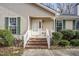 Front porch with brick stairs and green shrubbery at 1506 Poplar Ridge Rd, Fuquay Varina, NC 27526
