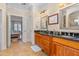 Spacious primary bathroom with double vanity, wood cabinets, and granite countertops at 4109 Cheek Point Pl, Burlington, NC 27215