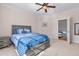 Spacious bedroom with blue bedding and a ceiling fan at 4109 Cheek Point Pl, Burlington, NC 27215