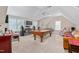Large bonus room with a pool table, entertainment center, and ample seating at 4109 Cheek Point Pl, Burlington, NC 27215
