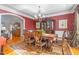 Formal dining room with dark wood furniture, red walls, and chandelier lighting at 4109 Cheek Point Pl, Burlington, NC 27215