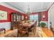 Elegant dining room with red walls, ornate chandelier, and classic furniture at 4109 Cheek Point Pl, Burlington, NC 27215