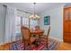 Elegant dining room with chandelier lighting and seating for four at 4109 Cheek Point Pl, Burlington, NC 27215