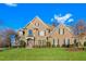Stately brick home with stone accents, manicured lawn, and welcoming front porch at 4109 Cheek Point Pl, Burlington, NC 27215