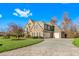 Three-car garage and paved driveway of a large brick home on a landscaped lot at 4109 Cheek Point Pl, Burlington, NC 27215