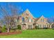 Brick home with stone accents, mature trees, and a well-maintained lawn at 4109 Cheek Point Pl, Burlington, NC 27215