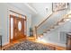 Grand foyer with hardwood floors, elegant staircase, and decorative rug at 4109 Cheek Point Pl, Burlington, NC 27215