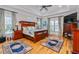 Large main bedroom with wood floors, tray ceiling, and plush carpeting at 4109 Cheek Point Pl, Burlington, NC 27215