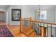 Staircase with hardwood floors and iron railing, and view to the front entrance at 4109 Cheek Point Pl, Burlington, NC 27215