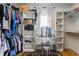 Walk-in closet featuring built-in shelving, hanging rods, and a vanity area at 4109 Cheek Point Pl, Burlington, NC 27215