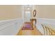 Elegant entryway with hardwood floors, wainscoting, and decorative rug at 4137 Gardenlake Dr, Raleigh, NC 27612
