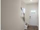 Welcoming entryway with wood-look flooring, white door, and carpeted staircase at 447 Belgian Red Way, Wake Forest, NC 27587