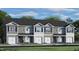 Attractive two-story townhome with gray siding, white trim, and a one-car garage at 447 Belgian Red Way, Wake Forest, NC 27587