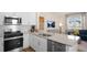 Modern kitchen with white cabinets, stainless steel appliances, granite countertops, and breakfast bar at 447 Belgian Red Way, Wake Forest, NC 27587